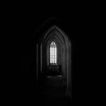 monochrome photo of dark hallway